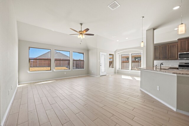 unfurnished living room with sink, light hardwood / wood-style flooring, and ceiling fan