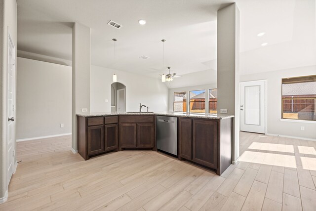 kitchen with dishwasher, sink, light stone countertops, and light wood-type flooring