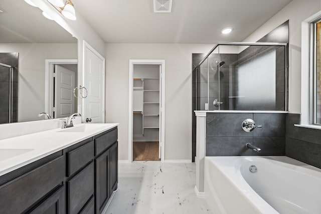 bathroom featuring vanity and shower with separate bathtub