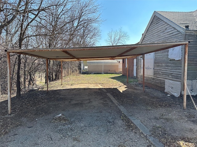 view of parking / parking lot featuring a carport