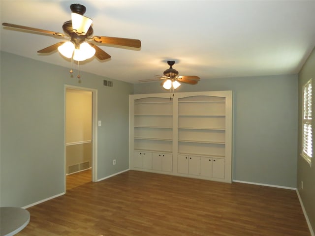 unfurnished living room featuring dark hardwood / wood-style flooring and ceiling fan