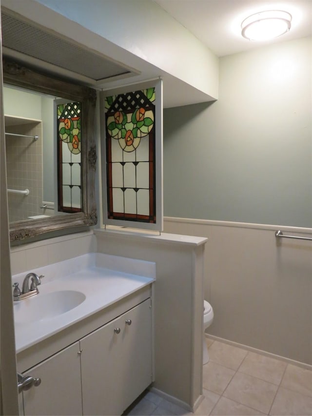 bathroom featuring tile patterned flooring, vanity, and toilet