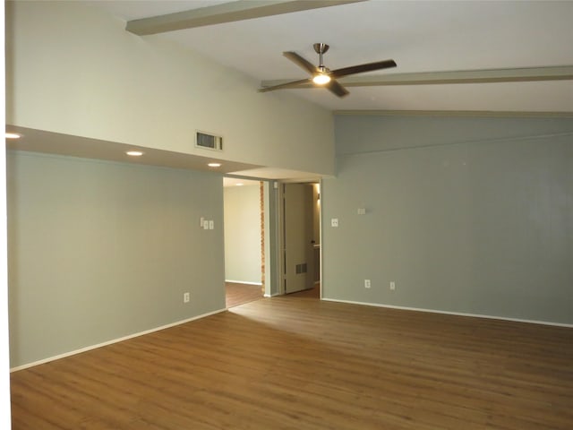 spare room featuring hardwood / wood-style flooring, ceiling fan, and lofted ceiling with beams