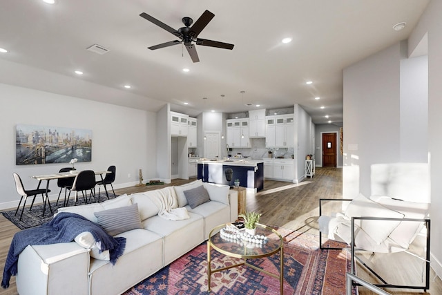 living room with hardwood / wood-style flooring and ceiling fan