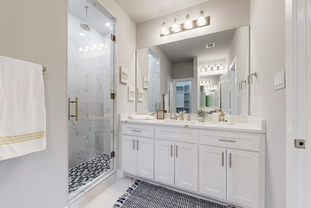 bathroom with vanity and a shower with shower door