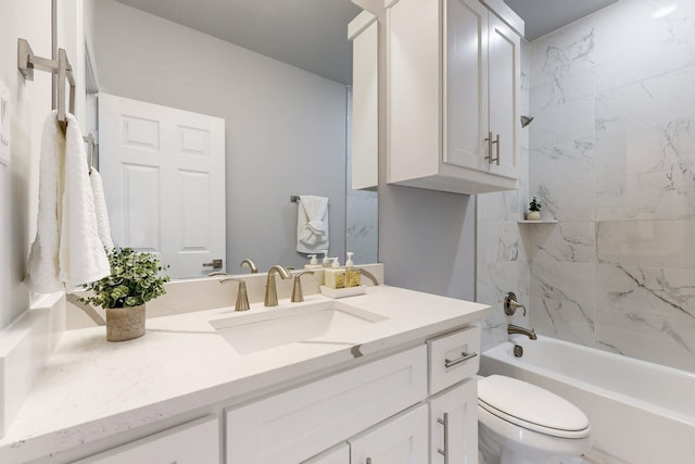 full bathroom with vanity, tiled shower / bath combo, and toilet