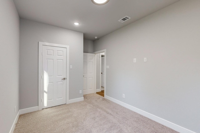 unfurnished bedroom with light colored carpet