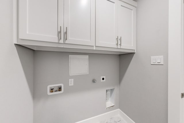 clothes washing area with cabinets, electric dryer hookup, and hookup for a washing machine