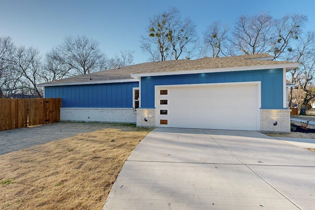 ranch-style house featuring a garage and a front lawn