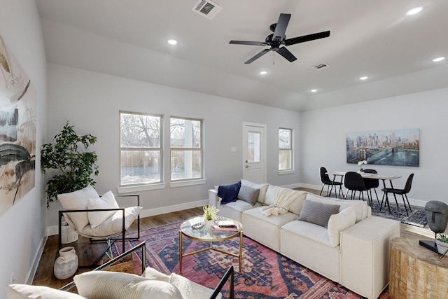 living room featuring a wealth of natural light, hardwood / wood-style floors, ceiling fan, and a fireplace