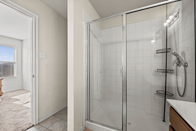 bathroom with tile patterned flooring, vanity, and a shower with door