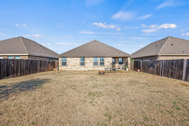 rear view of property with a yard