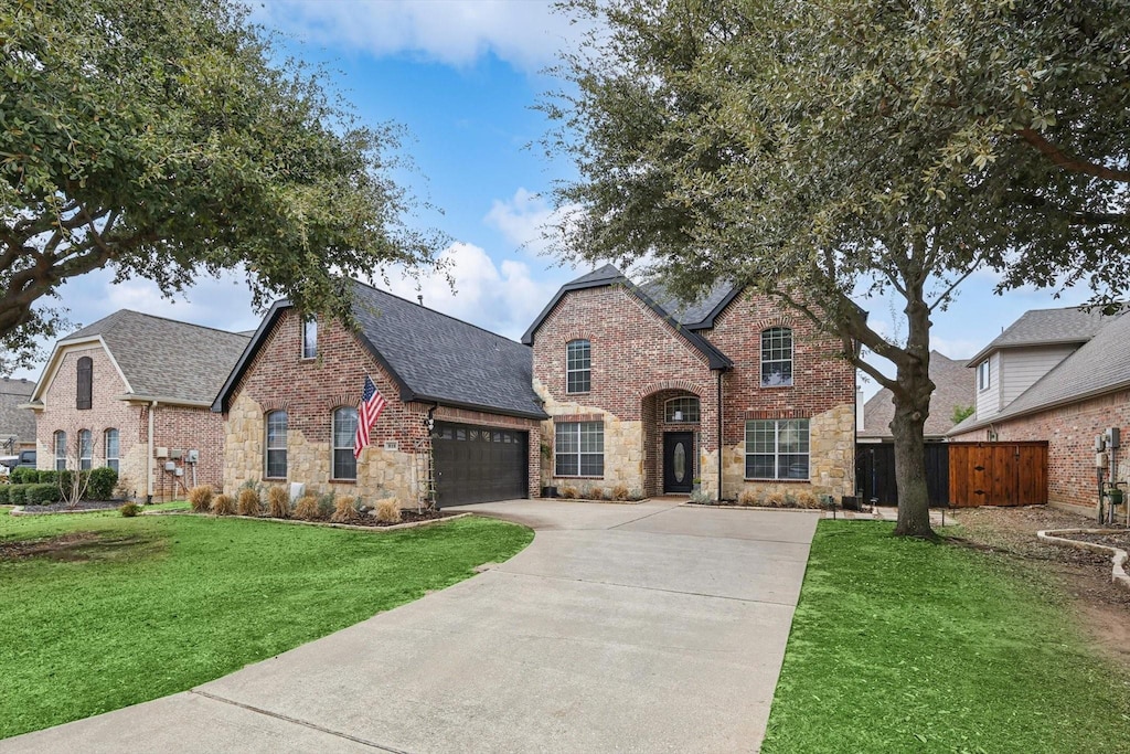 view of front of property with a garage and a front yard