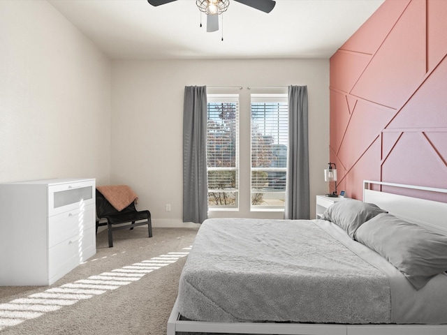 bedroom featuring light carpet, ceiling fan, and baseboards