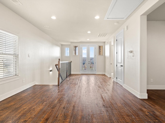 unfurnished living room featuring baseboards, french doors, visible vents, and recessed lighting