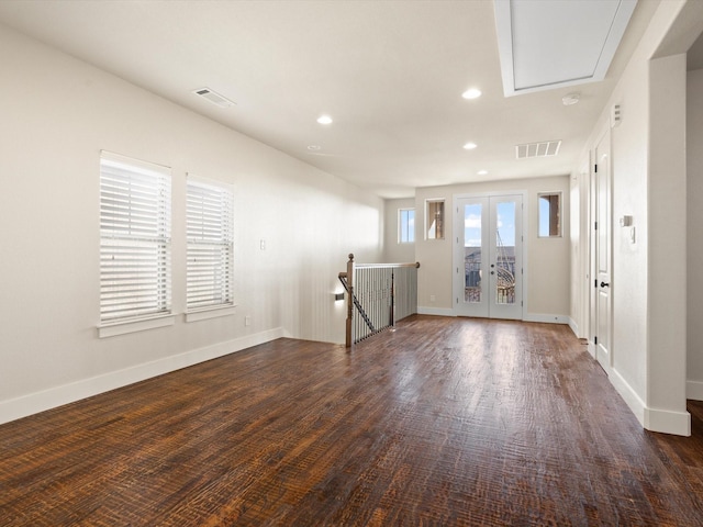 unfurnished room with baseboards, french doors, visible vents, and attic access