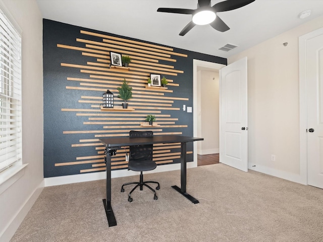 office with an accent wall, a wealth of natural light, carpet, and visible vents