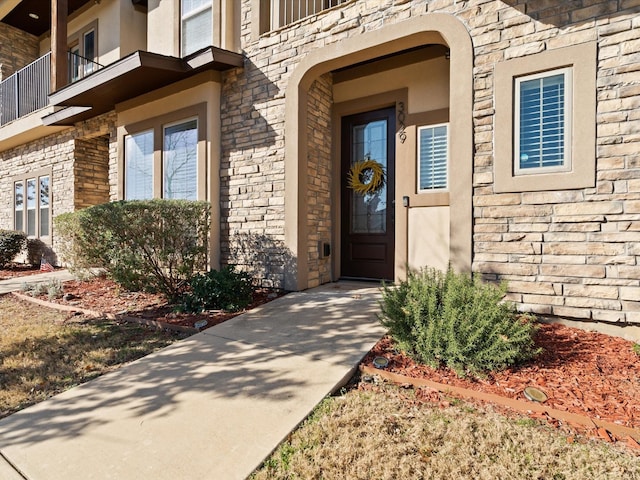 entrance to property featuring stucco siding