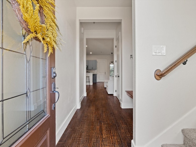 interior space featuring dark wood-style floors, stairway, and baseboards