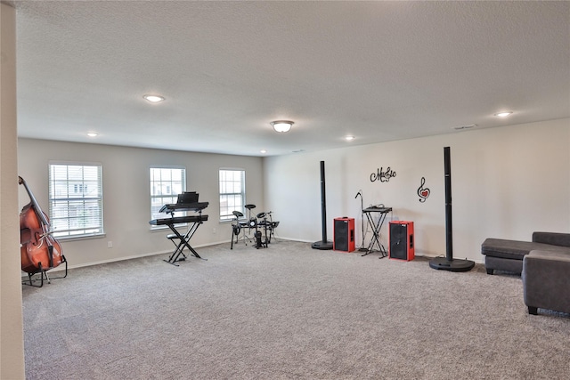 playroom with light colored carpet and a textured ceiling