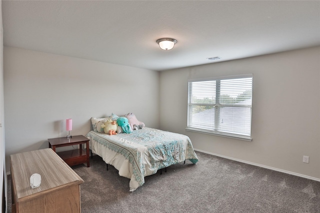 bedroom featuring dark colored carpet