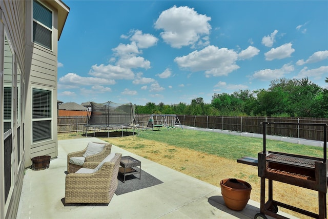 view of yard with a playground, a patio area, and a trampoline