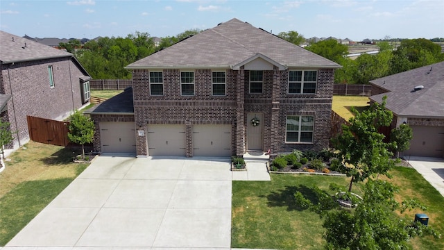 view of front of property with a garage and a front lawn