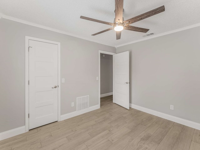 unfurnished bedroom with ornamental molding and light hardwood / wood-style floors