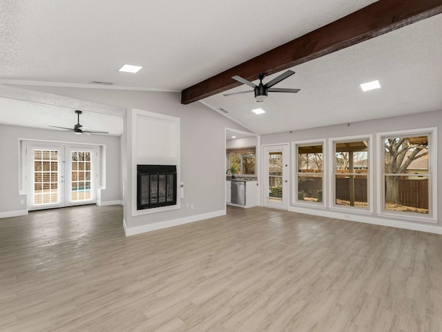 unfurnished living room with vaulted ceiling with beams, light hardwood / wood-style flooring, a textured ceiling, and ceiling fan