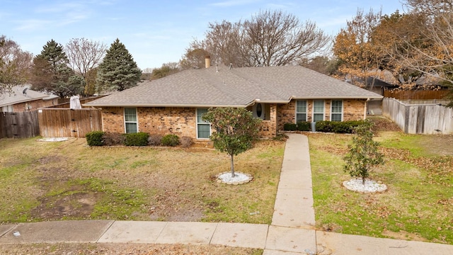 ranch-style home with a front lawn