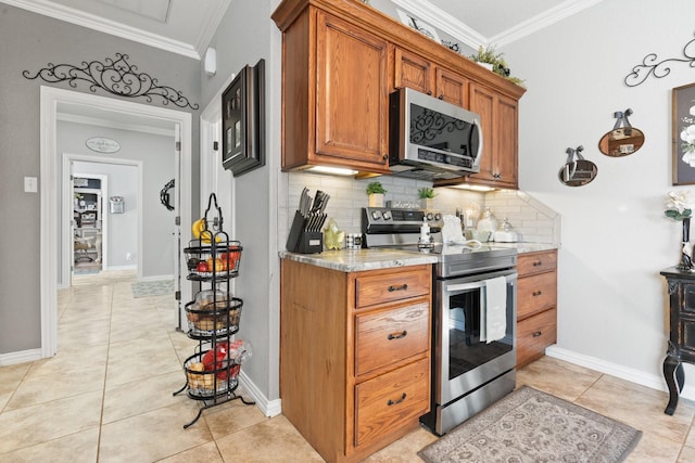 kitchen featuring stainless steel appliances, crown molding, light tile patterned floors, and decorative backsplash