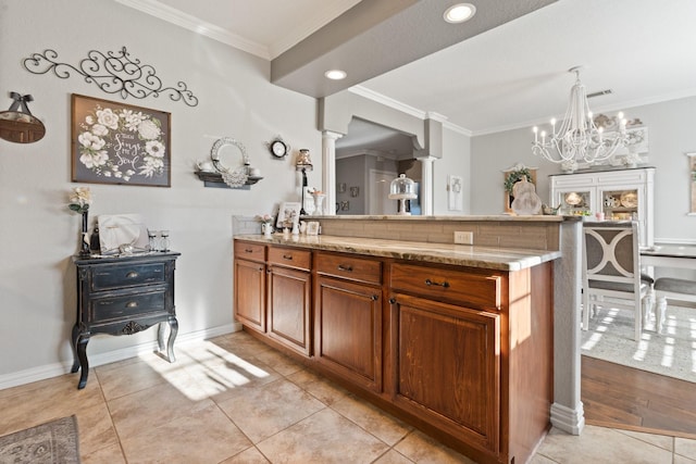 bathroom with tile patterned flooring, crown molding, and vanity