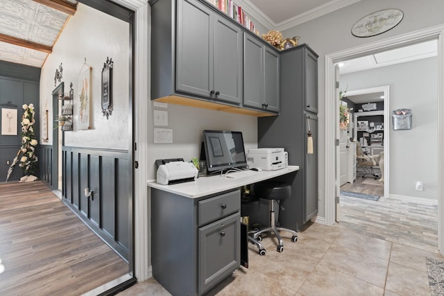 home office with light tile patterned floors and ornamental molding