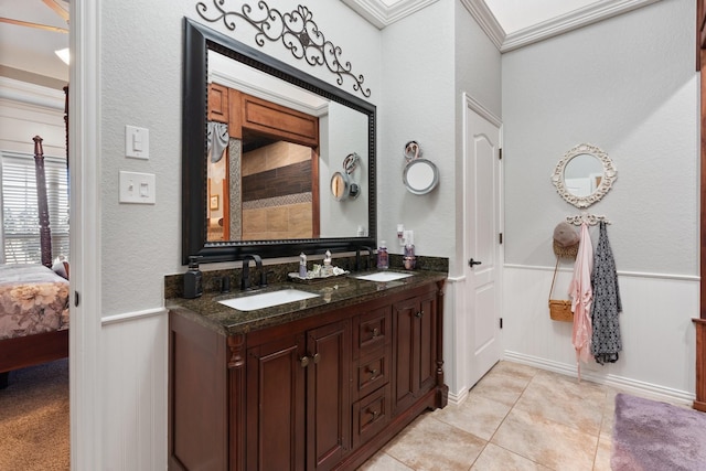 bathroom with crown molding, vanity, and tile patterned flooring