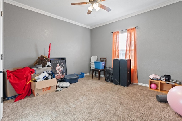 game room with ornamental molding, carpet, and ceiling fan