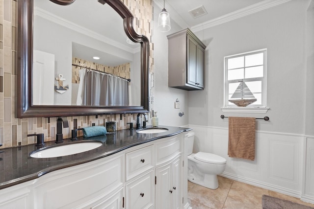 bathroom with crown molding, tile patterned floors, toilet, and vanity