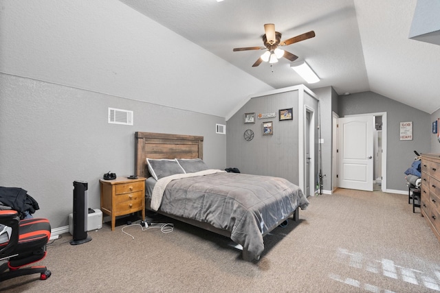 carpeted bedroom featuring ceiling fan, vaulted ceiling, and a textured ceiling