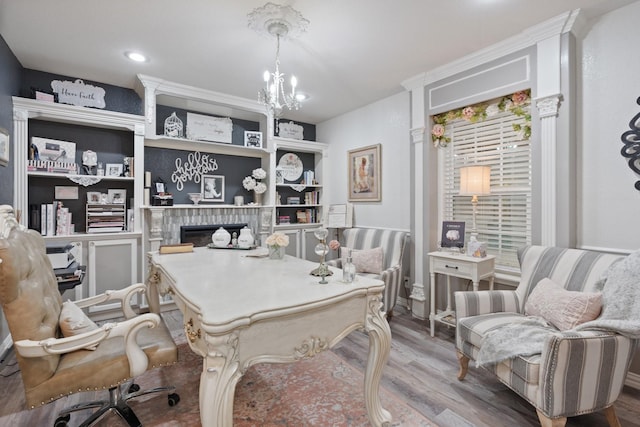 office space featuring an inviting chandelier and hardwood / wood-style flooring