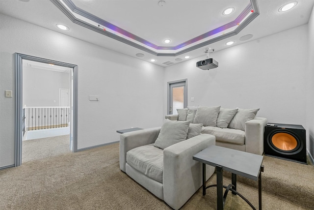 carpeted home theater featuring visible vents, a raised ceiling, crown molding, and recessed lighting