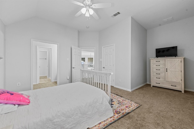 bedroom with lofted ceiling, carpet floors, visible vents, and baseboards