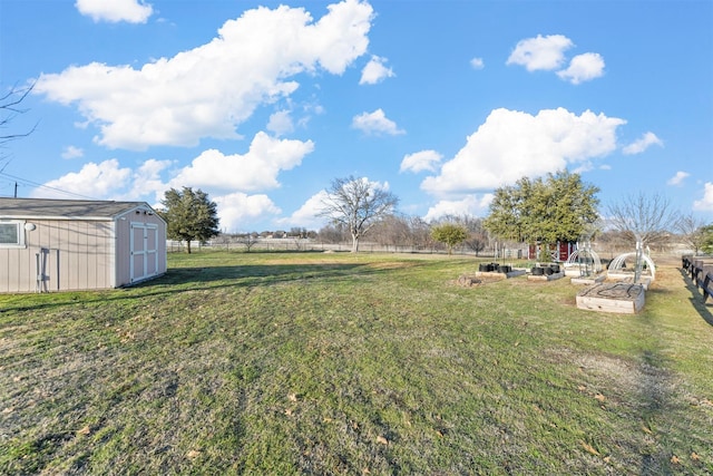 view of yard with a storage shed, an outdoor structure, and fence