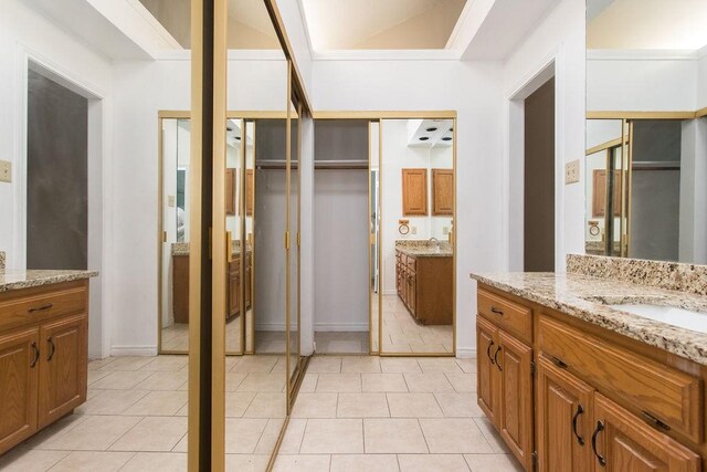 bathroom featuring vanity, tile patterned flooring, and ornamental molding