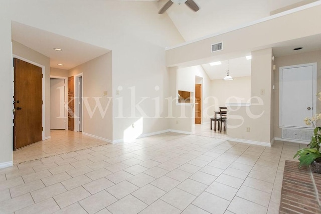 tiled empty room featuring high vaulted ceiling and ceiling fan