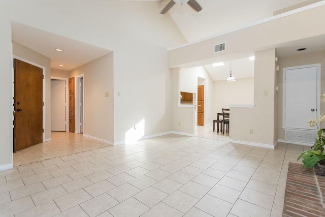 tiled spare room with high vaulted ceiling and ceiling fan