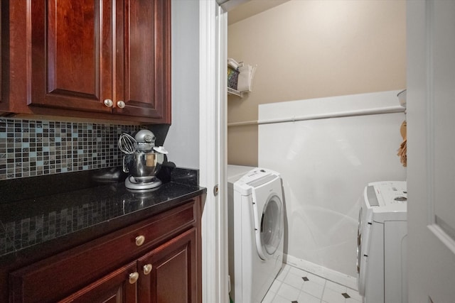 laundry area with light tile patterned floors and washing machine and clothes dryer