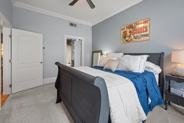 bedroom with crown molding, light colored carpet, connected bathroom, and ceiling fan