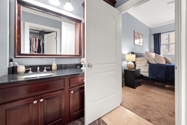 bathroom featuring tile patterned flooring, crown molding, and vanity