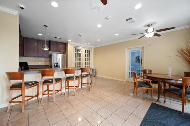 kitchen featuring stainless steel fridge with ice dispenser, dark brown cabinets, ornamental molding, and ceiling fan