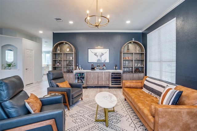 living room featuring wine cooler, bar area, crown molding, and light wood-type flooring