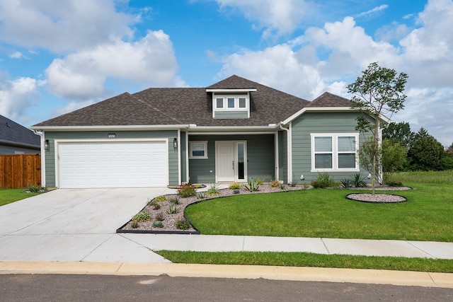 view of front facade with a garage and a front yard